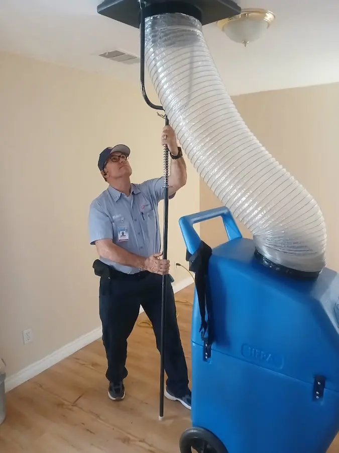 Furnace Tune-Up technician using HEPA equipment in El Dorado